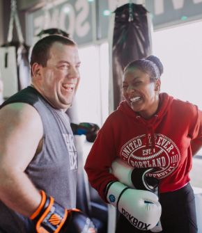 Two happy RockBox members in the middle of a kickboxing workout